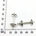 Antique silver dumbbell charms for DIY jewelry making set against a measuring scale - Barbell Dumbbell Weightlifting Style (9011)