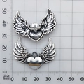 Vintage silver wing heart pendant in alloy showing dimensions on a grid scale ruler - B220 Antique Silver Peach Heart Wing (B220)