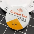 Close-up of 0.8mm Crystal Tec elastic bead cord on a ceramic plate for DIY jewelry - Transparent 0.8mm Elastic Cord