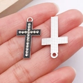 Cross pendant with black enamel inlay and clear rhinestones shown in hand - Silver Black Enamel Cross (27038)