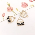 Golden quilted handbag charm with black enamel and a sparkling diamond accent - Black Bag Style (12293)