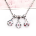 Macro shot of silver snake chain with white enamel snowflake pendants and colorful rhinestones - Snowflake Rhinestone Charm (15211)