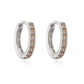 Silver huggie hoop earrings with sparkling amber stones shown on white reflective background - Silver Tone Champagne Rhinestone
