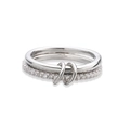 Macro shot of interlocking silver rings with polished metal band and pavé cubic zirconia stones - Platinum White Zirconia