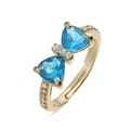 Detailed macro view of gold bow ring with blue gemstones and sparkling zircon pavé - Gold Sea Blue Zirconia