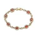 Macro view of gold vintage bracelet featuring oval red gems and white zircon inlay - Gold Red Zirconia