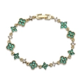 Detailed macro view of a gold clover bracelet with emerald green stones and pavé crystals - Gold Green Zirconia