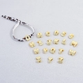 Macro view of gold 3D alphabet beads with polished mirror finish for DIY jewelry - Letter A / White Leopard Rope + Gold Letter