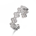 Macro detail of silver clover ring with sparkling zircon flowers and adjustable band - White Gold / White Zircon