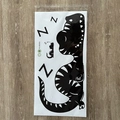 Detailed view of FX-B265A sleeping dinosaur wall sticker in its clear plastic packaging - 30*60cm (FX-B265A)