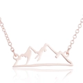Detailed macro of rose gold mountain peak pendant with elegant hollow silhouette - Rose Red