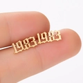 Macro shot of 1983 year stud earring in gold-plated gothic font style detail - 1983 Gold