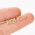 Macro shot of 1988 gothic number stud earrings in polished gold-plated finish - 1988 Gold