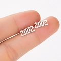 Macro shot of silver gothic 2002 birth year stud earrings held between fingers - 2002 Silver