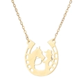 Macro shot of 18K gold horseshoe pendant with hollow horse and girl silhouette - Gold