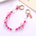 Close-up of pink heart-shaped beads and iridescent pearls on a stylish mobile phone strap - Mermaid Flower Beaded Handle Chain (With Pearl) / Rose Red