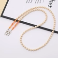 Detail of beaded wooden strap with orange accent beads and silver metal lobster clasps - Orange Yellow Peach Stone