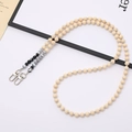 Close-up of wooden bead chain with marble accents and dual silver lobster clasps - Black White Fire Agate