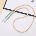 Detail of beaded cross-body chain with natural wood, green stones and silver clasps - Natural Green Aventurine Stone