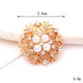 Detail showing a 2.4cm gold snowflake charm with white pearls and sparkling zircons - Pearl Snowflake