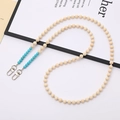 Crossbody phone strap with beige wooden beads, turquoise stone accents, and metal clasps - Turquoise Natural Stone