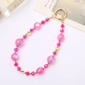 Detailed macro of pink mermaid bead phone strap with golden butterfly and spring ring - Rose Red