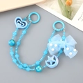 Detailed view of blue crystal beaded phone charm strap with heart and star moon charms - Hand Chain / Blue
