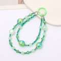 Détail de perles de cristal vertes et accents de feuilles d'or pour porte-clés - Vert
