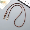 Close-up of brown braided leather strap with premium gold metal spring hook and ring - Brown