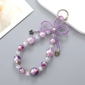 Detail of purple handmade beaded keychain with rhinestone bow and butterfly charms - Purple