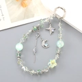 Detail of beaded keychain with iridescent star charms and mint green faux pearls - Green