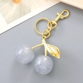 Creative cherry keychain with gold metal stem and purple glitter resin beads - White