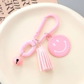 Pink keychain with smile charm, tassel, and bell accessory for backpacks and purses - Pink