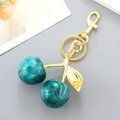 Creative resin cherry keychain with green marble texture and golden leaf ornament - Emerald Green