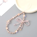 Pink beaded phone charm with bow design and crystal beads on a ceramic plate - Phone Chain / Pink (K4986)