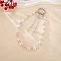 Detailaufnahme der Perlenkette mit rosa Kristallen, Perlen und Strass-Schleifen-Anhänger - Strass Schleife Anhänger / Rosa (K5045)