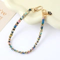 Detail of woven fabric and metal chain strap with a camellia pendant and gold lobster clasps - Handle Charm (K5024) / Blue