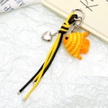 Detail of crochet fish charm with leather cord and silver heart pendant on white texture - Orange Fish Style (K5131)