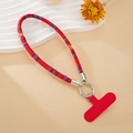 Detail of red ethnic style embroidered braided phone wrist strap with silver ring clip - Red