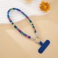 Detail view of ethnic woven phone wrist strap with blue tab and silver ring connector - Blue