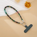 Close-up of ethnic woven phone wrist strap with silver metal clasp and gray t-patch - Green