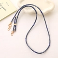 Detailed view of woven phone strap with purple geometric pattern and gold metal hooks - Sky Blue