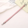 Pink PU leather phone strap with silver dual lobster clasps in a lifestyle setting - Cross Pattern Leather Hand Chain / Pink