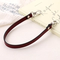 Detailed view of dark red PU leather wrist strap with silver metal swivel hooks - Cross Pattern Leather Hand Chain / Burgundy