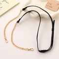 Detail view of adjustable black PU leather shoulder strap with gold metal chain - Black