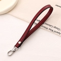 Detailed view of dark red lychee leather wristlet strap with silver lobster clasp and rivets - Cross Pattern Leather Hanger / Burgundy