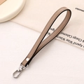 Close-up of brown PU leather hand strap with silver swivel lobster clasp and stitching - Cross Pattern Leather Hanger / Khaki