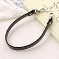 Detail of grey PU leather bag strap with silver metal lobster clasps and smooth edges - Cross Pattern Leather Hand Chain / Gray