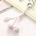 Detail of cream-white woven PU leather double ball charm with silver metal ring clasp - White