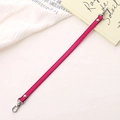 Close-up of rose pink PU leather strap with silver lobster clasps and metal rivets - Cross Pattern Leather Hand Chain / Rose Red